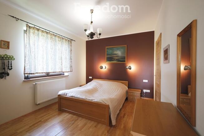 Dom ze stawem nad rzeką pośród pól i łąk