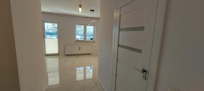 Nowoczesna kawalerka z ogrodowym tarasem i miejscem postojow