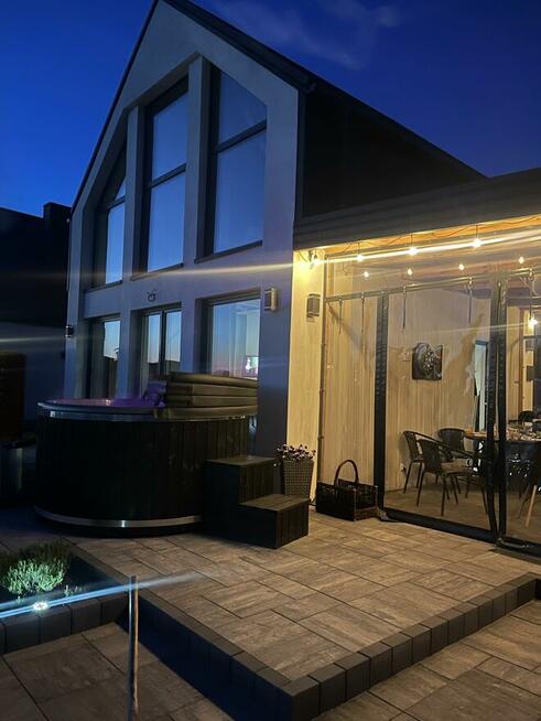 Domek z linia brzegową oraz pomostem nad jeziorem Kopiec