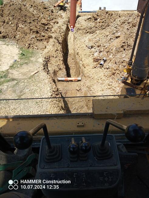 usługi koparko-ładowarką cat.