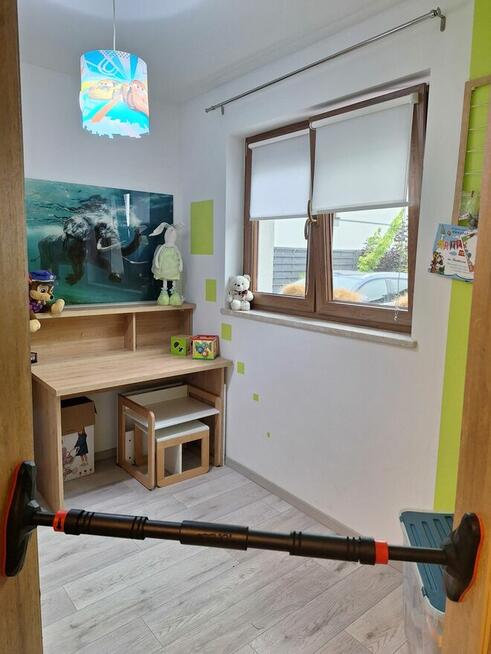 Dom szczytowy z ogrodem zimowym i garażem.