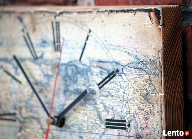 Zegar na desce sosnowej ze starą mapą świata.