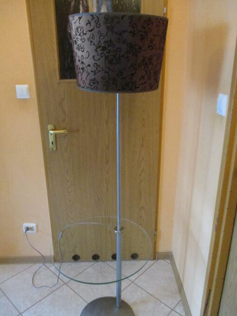 Lampa stojąca z półką szklaną.