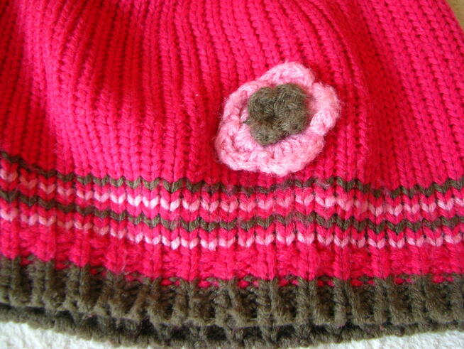 Malinowa włóczkowa czapeczka dziewczęca z uroczym kwiatuszki