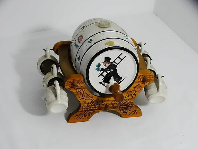 Dystrybutor w kształcie beczki, osadzony na rzeźbionym stoja