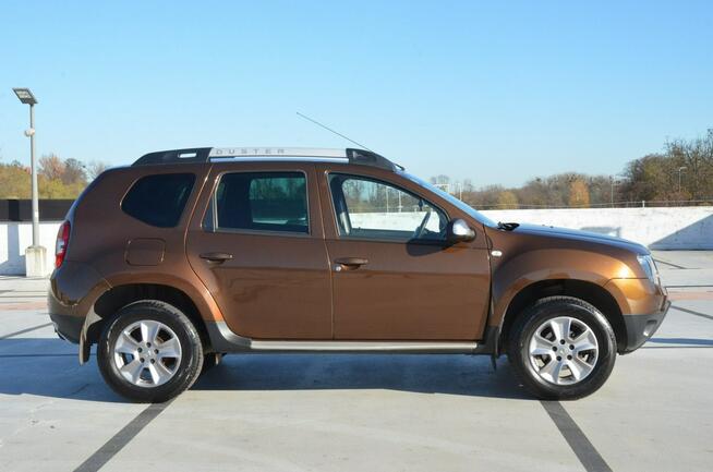 Dacia Duster 1.6i 105 KM Klima/ Navi/ Alu/ Ele. szyby/ Relingi/ Krajowy
